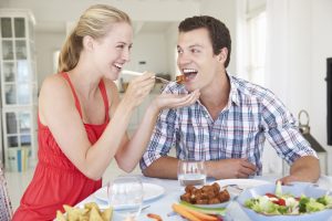 Young Couple Enjoying Meal At Home